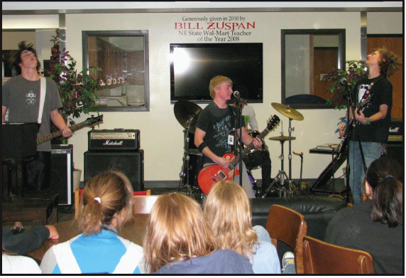 Left to Right: Grant Versaw(11), Josh Wolz(11), and Jordan Radcliff(12) of the band “Light the Fuse” perform for students in the Lincoln High media center on October 22. Photo by Seth Marshall