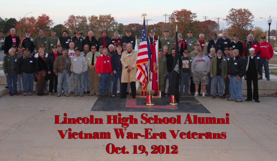 Over 50 Lincoln High alumni Vietnam War-Era veterans gathered in the front of the school on Friday, Oct. 19, 2012 to reminisce before a ceremony to honor their service.  Veterans from all branches of the military assembled with the United States flag in front of the Beechner Field stands during halftime of the LHS vs. Grand Island varsity football game while the crowd of students and parents cheered and applauded. Photo by Greg Keller