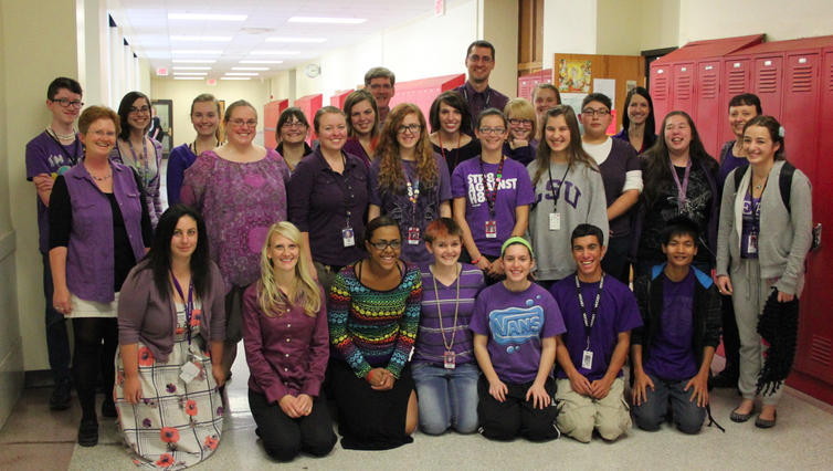 Students and staff dressed in purple gather for a photo at the end of Spirit Day today, Thursday, Oct. 17, 2013 as a sign of support for LGBT youth and to speak out against bullying
