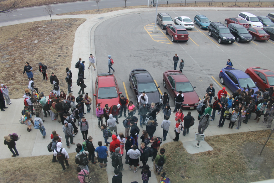 Students evacuate the building a second time in the same day due to a fire alarm on Thursday, Jan. 29, 2015. This alarm was prompted by burning wrestling mats in the South Gym hallway. 