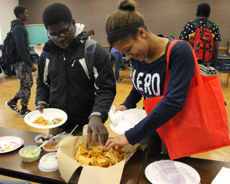 Seniors Rawson Ngoh and Raven Williams help themselves to food provided by College Club during a lunch program on Dec. 12, 2014. The club gives students opportunities to prepare for college. 
