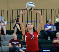 Lincoln High setter, Hannah Burianek
sets the ball up for a kill against Northeast.
