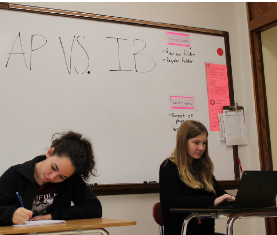 Jessica Olson and Peyton Erickson
represent the differences in AP and IB.
Photo by: Baylee Colburn