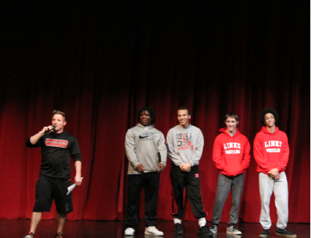 Above: Lincoln High Wrestling head coach Andy Genrich presents the four state qualifiers for the season at Ted Sorensen Theatre before going to the state tournament at Centurylink Center in Omaha. Wrestlers from the left, Terry Jones, Hunter White, Wesley Dawkins, and Aidan Arnold.