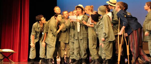 The cast of the 2017 fall play performs last scene of the production, M*A*S*H, at the Ted Sorensen Theatre at Lincoln High. Photo by Audrey Perry.