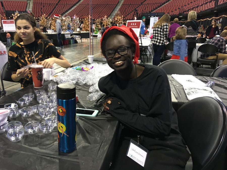 LHS seniors Nyayaang Luak (front) and Crystal Mann (back) volunteer at the ornament decoration station at the Starry Nights Tree Festival at the Pinnacle Bank Arena from November 24 through November 26, 2017. Photo by Audrey Perry
