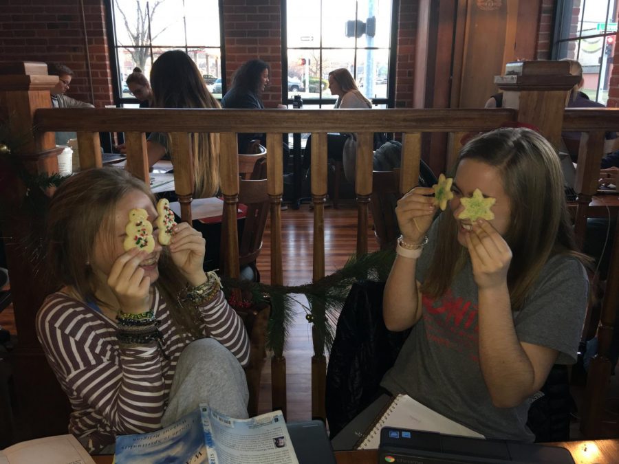 LIly Reineke (11) and Maicee Ingwerson (10) enjoy some holiday cookies after school. Photo by Grace Miller 