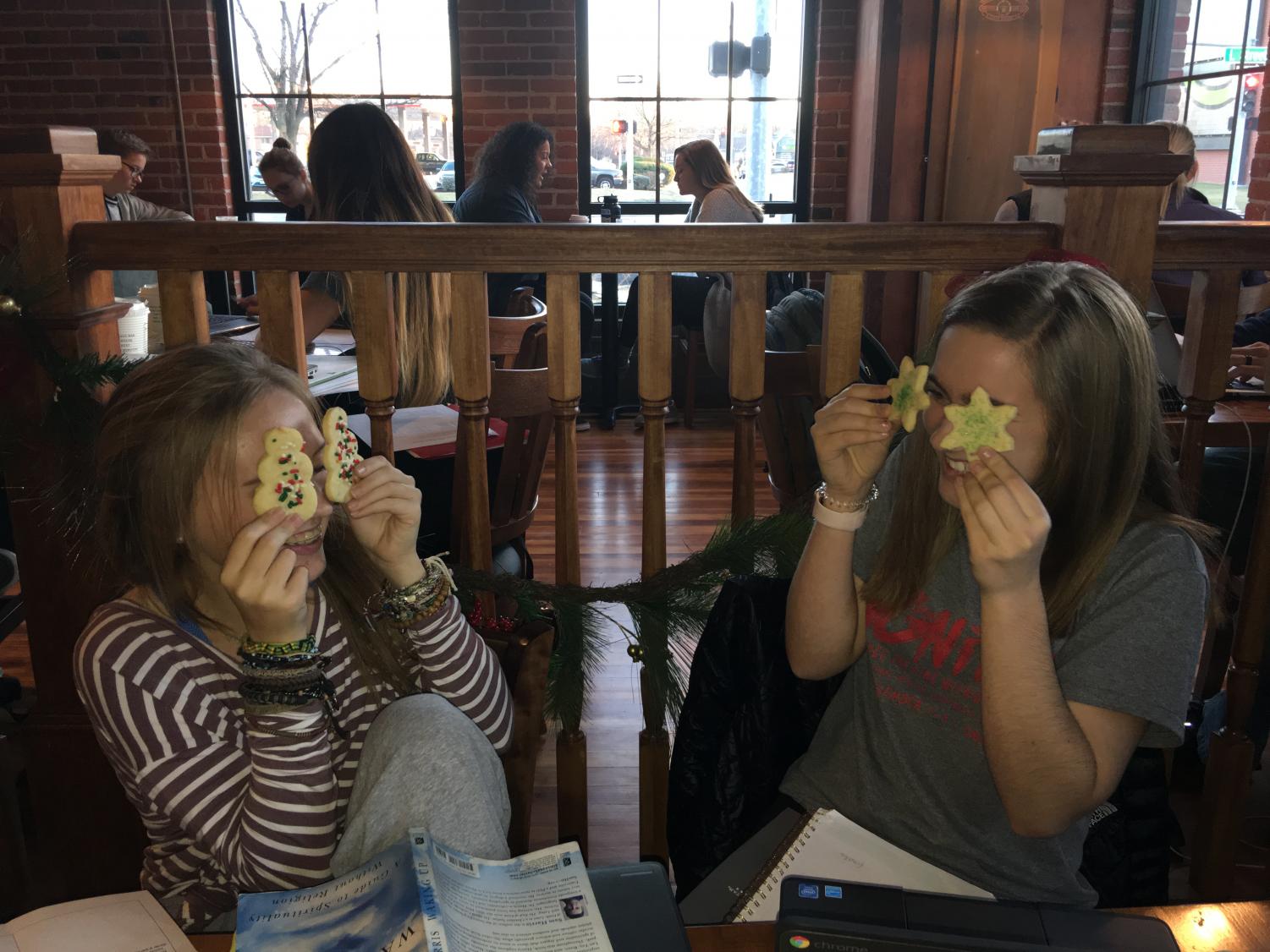 LIly Reineke (11) and Maicee Ingwerson (10) enjoy some holiday cookies after school. Photo by Grace Miller