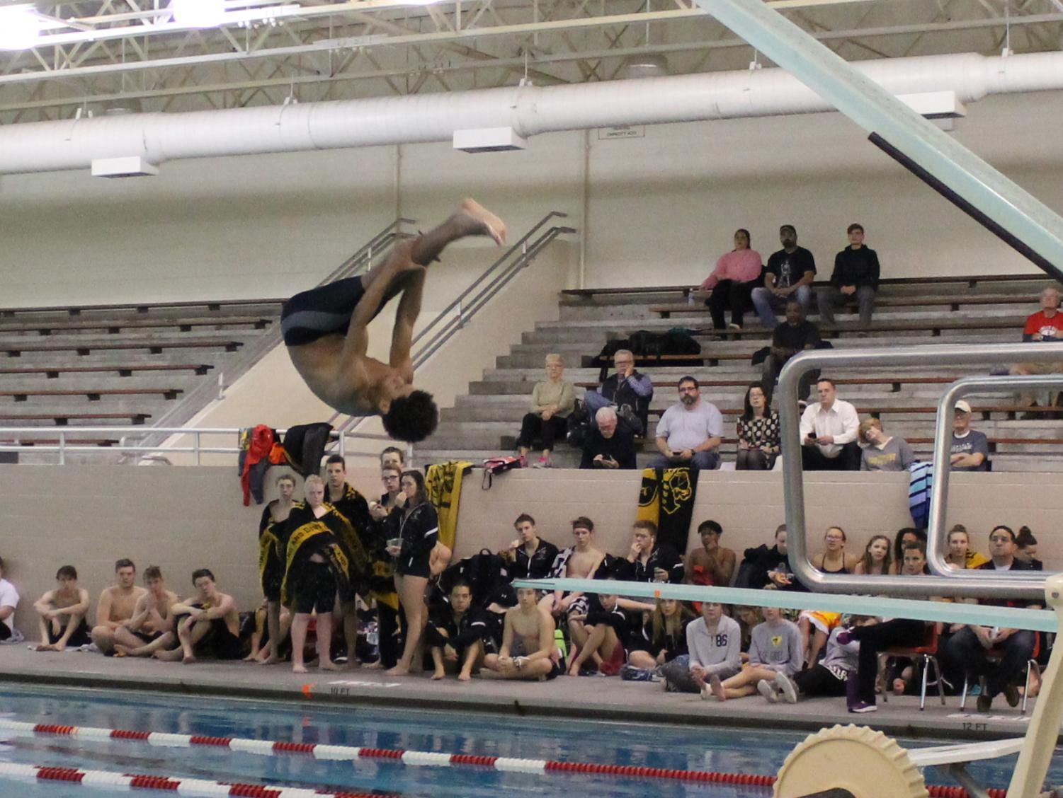 Isaiah Winston (10) does a forward double pike for his second dive at a triangular meet held at Lincoln High on January 25th, 2018 against Fremont and Southeast. Winston scored 320 points at this meet and qualified (again) for state.
Photo by Madeline Walker.