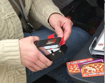 Music director Jill Oekten punches out guitar picks with the "pick punch." Photo by Grace Miller 