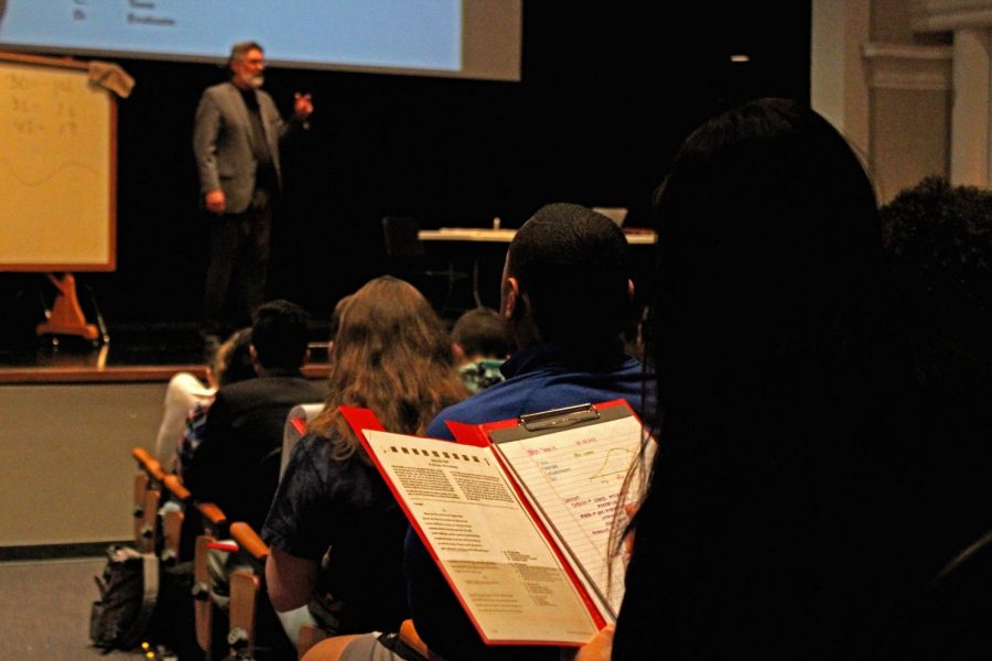 Speaker Chuck Ladd, a high school English teacher from Oklahoma speaks on the stage in the Ted Sorensen theatre on March 28, 2018 as LHS students take notes at an ACT prep seminar. 