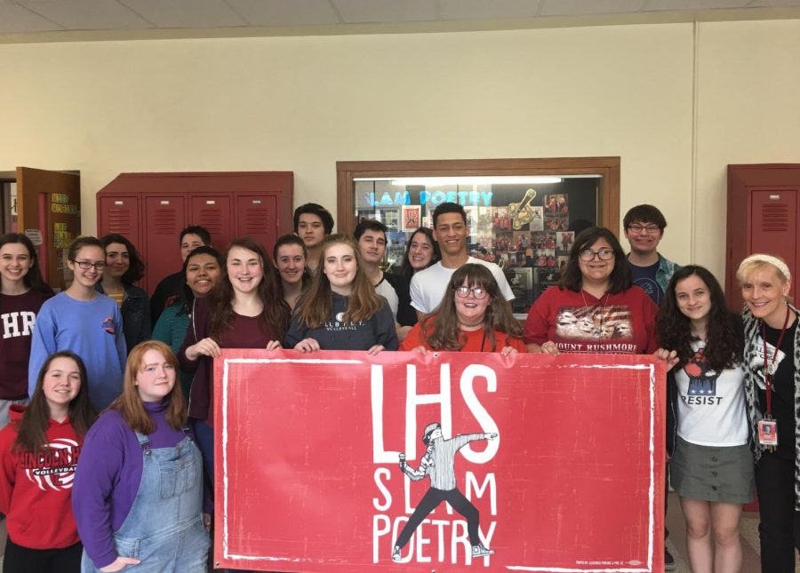 The 2018 LHS Slam Poetry Team poses with their new banner in preparation for their state bout which will be on Tuesday, April 24, 2018 at the Louder Than A Bomb Team Finals at the Holland Center, Omaha - 1200 Douglas St. beginning at 7 p.m.  Photo courtesy of Deborah McGinn