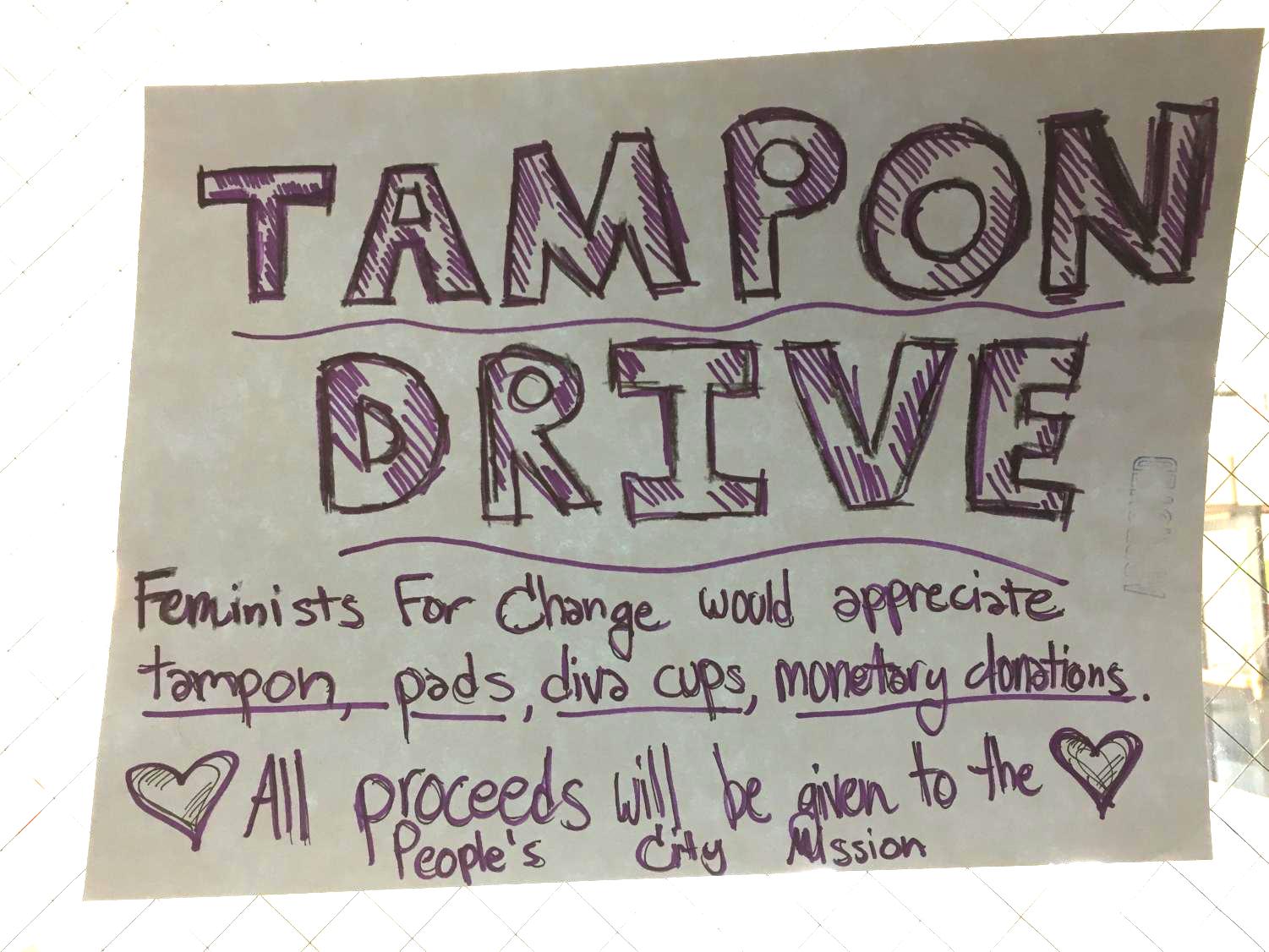 One of many posters from around the building giving information about the Tampon Drive. Advocate file photo.
