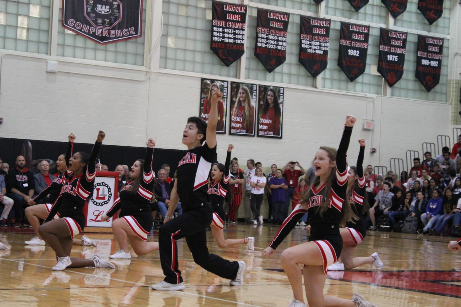 The Varsity Cheerleaders finish their routine to pump up the crowd during the Athletic Hall of Fame Fall Homecoming Pep Rally on Friday, Sept. 21, 2018 in the Johnson Gym. Photo by Aliyana Als