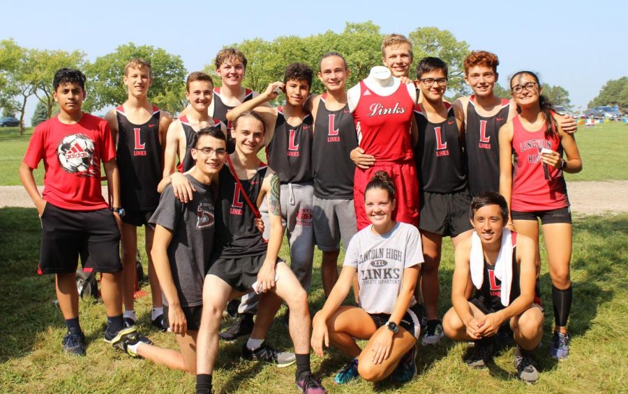 Some members of the Lincoln High Cross Country celebrate with Humphry, the new mascot, during the time trials at Pioneers Park on Sept. 18, 2018. Photo by Anh Mai