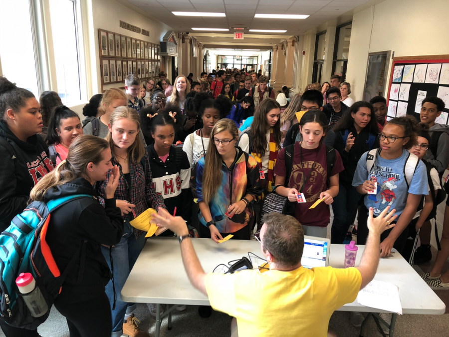 Student Council sponsor Carter Hulinsky tries in vain to get students to form a single line as they pack the main office hallway after school on Wednesday, Sept. 19, 2018 in a last-minute rush to get Homecoming tickets at the $5 price. The line extended almost all the way to the Counseling Center. Tickets went up to $10 on Thursday and will not be sold on Friday. This year’s theme is Friday Night Fever. 