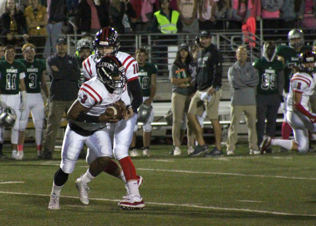 Senior quarterback #10 Cedric Case hands the ball to senior running back #3 Isaiah Alford during the Varsity Football game at Seacrest Field on Friday, October 19, 2018. The Links defeated Lincoln Southwest 43-3. Photo by Zeke Williams