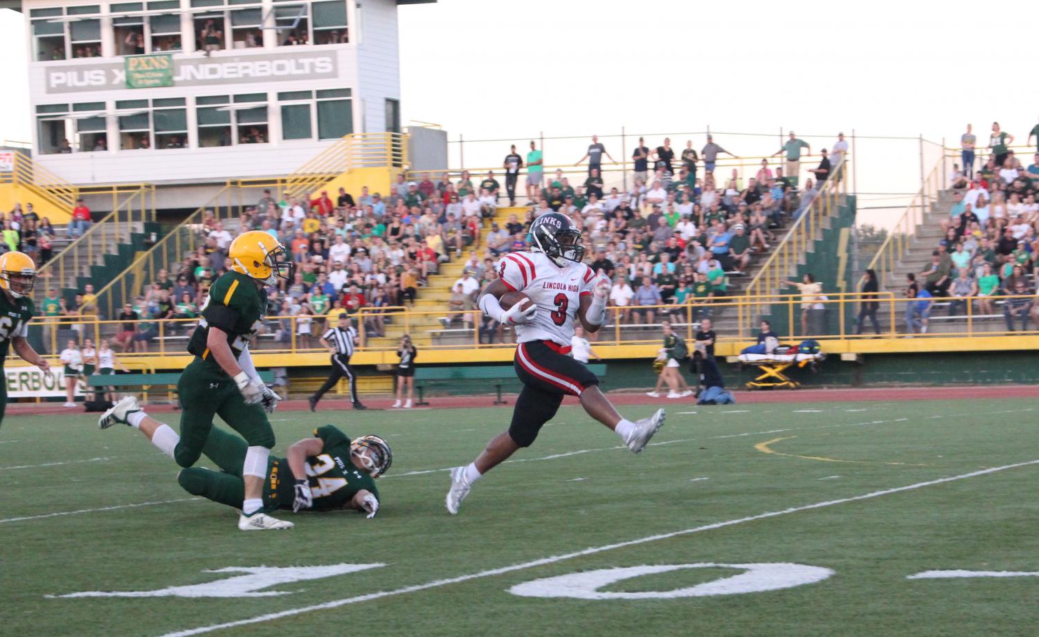#3 Isaiah Alford (12) runs the ball to the end zone for the first touchdown of the night against Lincoln Pius X on Friday, September 14th, 2018 at Pius High School. Photo by Zeke Williams
