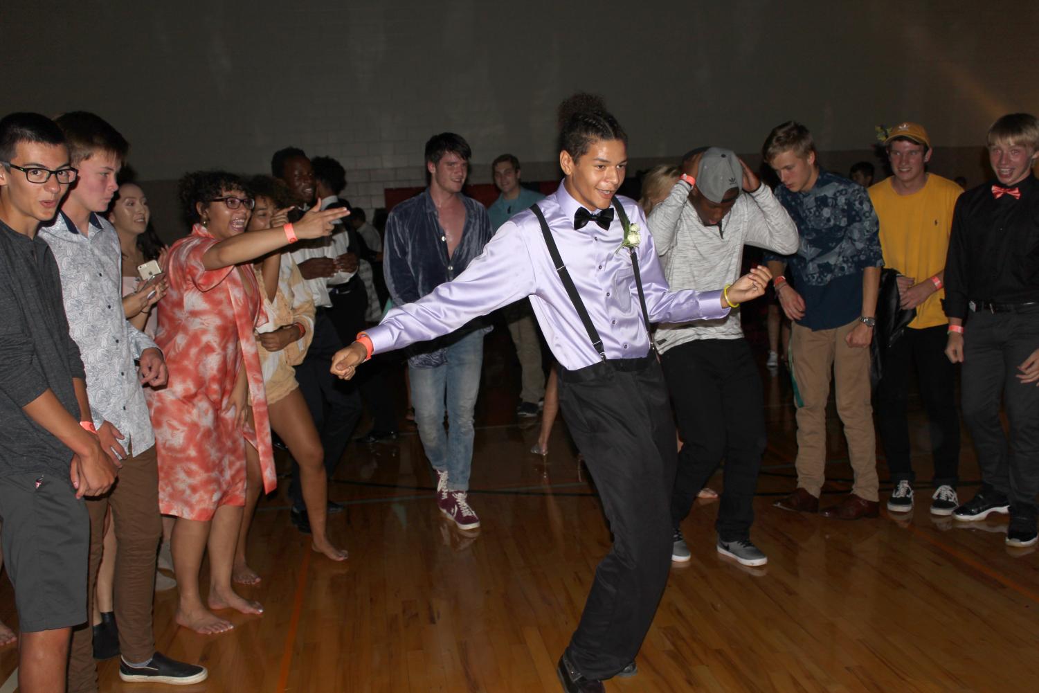 Levelle Foster (9) gets his grove on during the Friday Night Fever Homecoming Dance on Friday, Sept. 21, 2018 while other students cheer him on. Photo by Clementine Ewomsan.