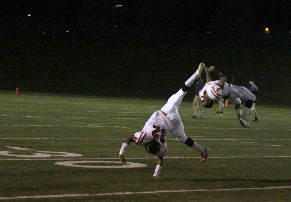 Lincoln High Varsity Football players #32 Morgan Perry (12) and #3 Isaiah Alford (12) cartwheel and flip across Seacrest Field, Friday October 19th, to celebrate their 43-3 victory against Lincoln Southwest. Photo by Zeke Williams.