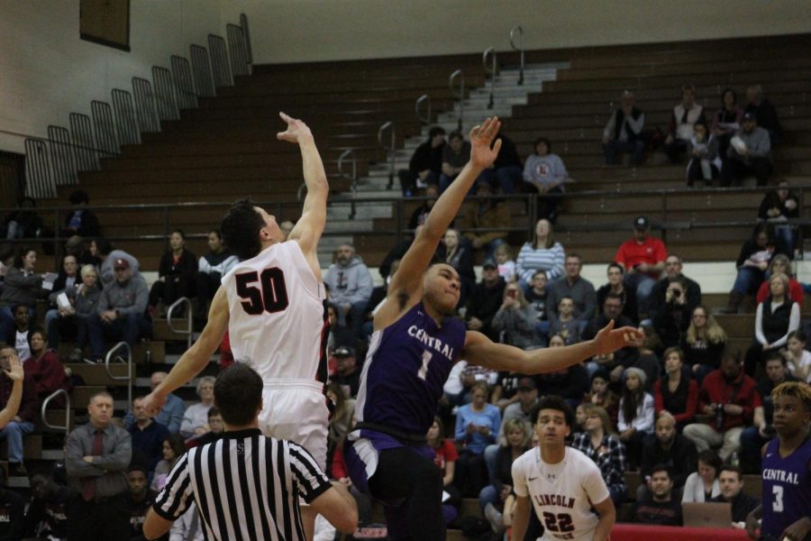 Senior #50 Graham Newton jumps up at tip off against Omaha Central High School on Saturday, January 12th, 2019.  Photo by Zeke Williams