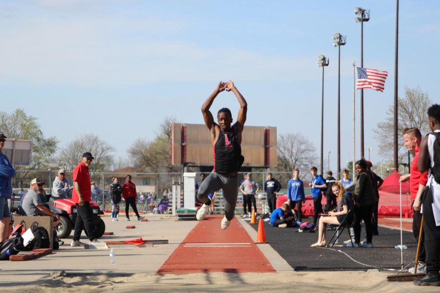 Senior Passmore Mudundulu triple jumps at the annual Harold C. Scott Varsity Track and Field Invitational at Beechner Athletic Complex on Wednesday, April 17th, 2019.  Mudundulu won the triple and long jump. 
 Photo by Angel Tran
