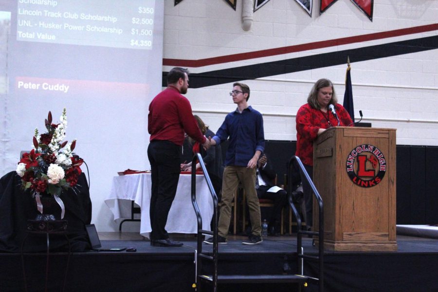 Student+Council+President+Eric+Lesiak+%2812%29+accepts+an+award+from+Music+Department+Chair+Brett+Noser+at+the+Senior+Honors+Assembly+on+May+13th%2C+2019.+Photo+by+Linh+Ngo