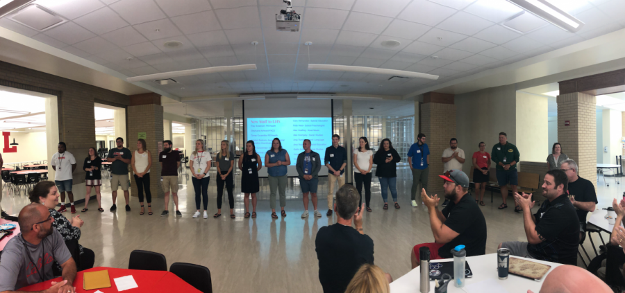 New staff members for the 2020 school year stand to be introduced by Principal Mark Larson at a staff meeting on August 5, 2019.  Lincoln High welcomed 18 new staff members this year. 