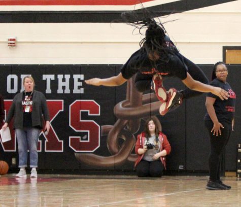 Airborne! Star Grandberry (11) stuns the crowd (and Ms. Swartz) with an amazing back flip during IIGs performance at the Winter Pep Rally on February 24, 2020. Photo by Greg Keller