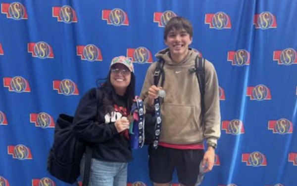 Mackenzie Wylie, Yearbook Sponsor and Eli Larson, senior, pose with medals at NSAA State Journalism Contest on April 23, 2024, in Norfolk, Neb.