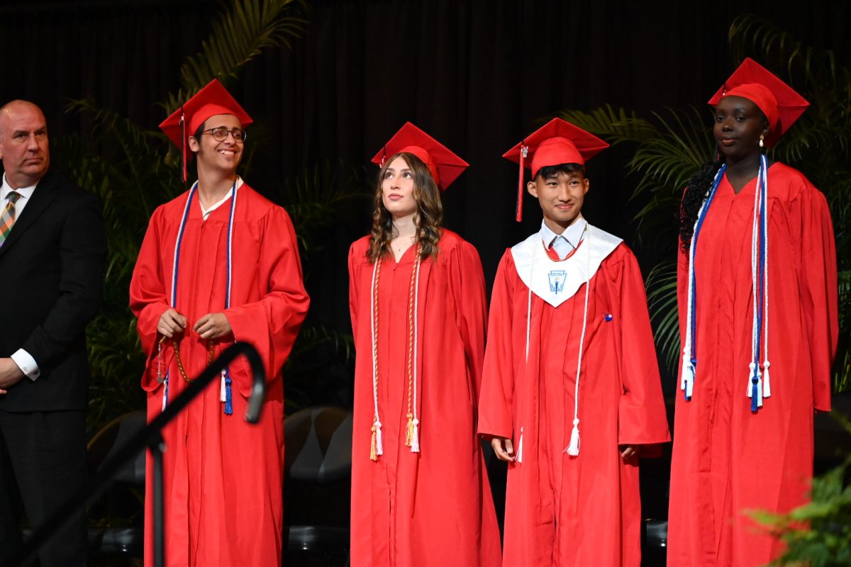 Superintendent of Schools, Dr. Paul Gausman and senior speakers Ali Waly, Sofia Caruso, Eh Ta Taw, and Sara Bilew on stage at the 2024 LHS Graduation Ceremony on Saturday.