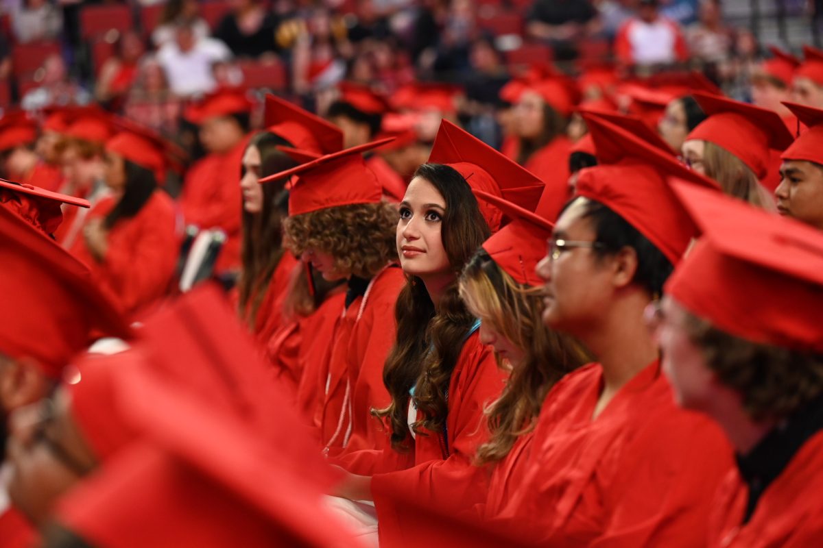 Senior Bayan Sheruza (center) and Senior Htee Gay Shee (right) take in the surroundings at the 2024 graduation ceremony on Saturday.