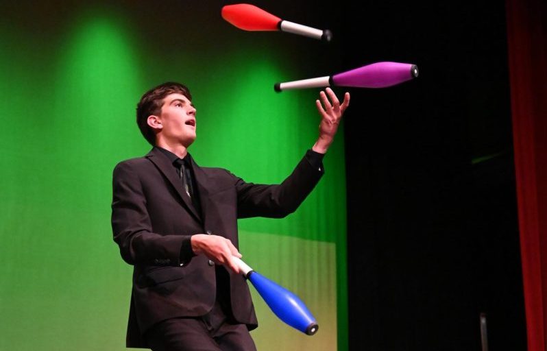 Sophomore Oliver Brassil juggles colorful pins during Joy Night