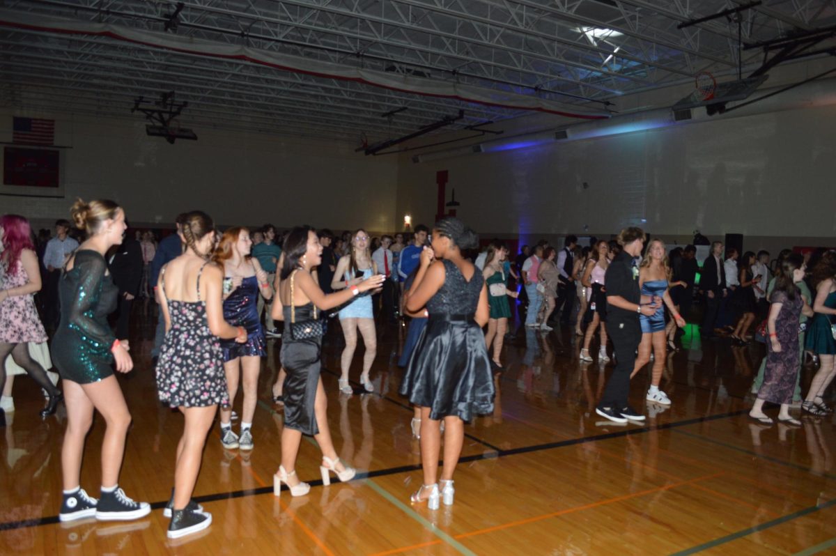 Students at Lincoln High homecoming dance and chat.