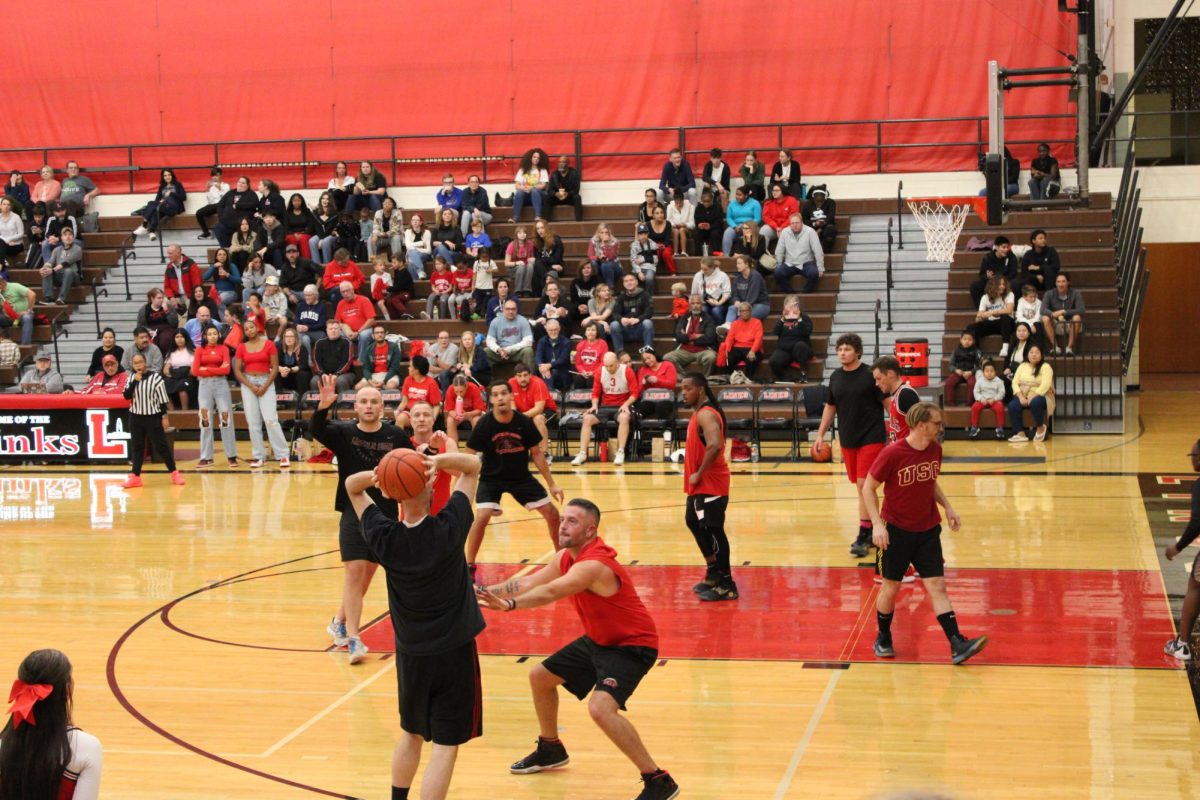 Black team attempts to pass the ball while red team plays defense at 2024 Hoops for Hope