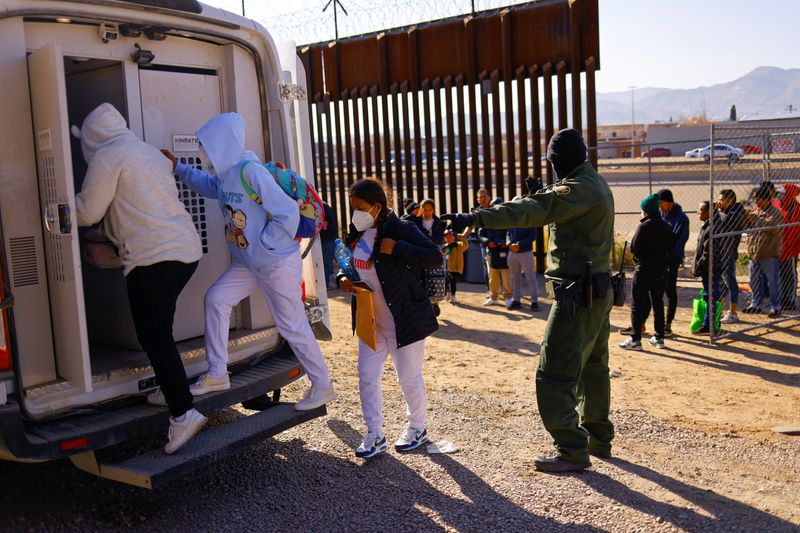 Migrants detained by U.S. Border Patrol agents after crossing into the United States from Mexico to request asylum get in a vehicle to be transferred to a detention center, in El Paso Texas, U.S. December 19, 2022. REUTERS/Jose Luis Gonzalez